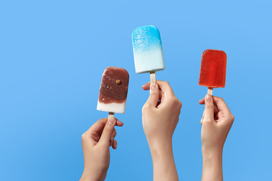 left and right hand holding Popsicle sticks isolated on white. - Powered by Adobe