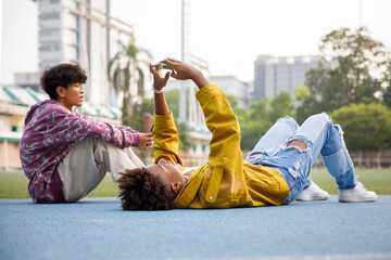 Bored teenagers hanging out at park on weekend