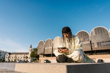 Stylish female using smartphones in city