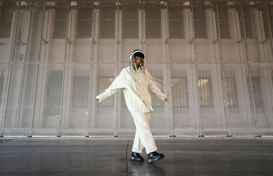 Stylish woman dancing in hangar