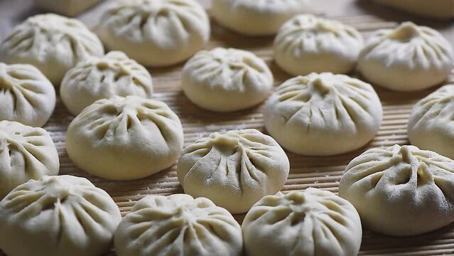 Homemade people making raw steamed buns. Delicious baozi,