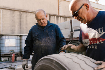 Mechanics checking the condition of a wheel.
