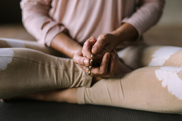Close up image of hands of a woman meditating and holding mudras