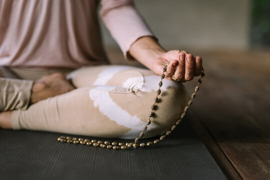 Close up image of hands of a woman meditating and holding mudras