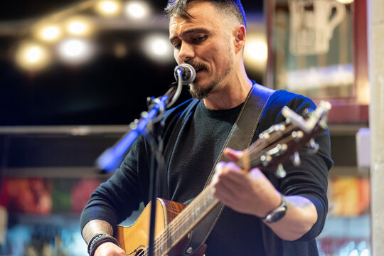 man singing with guitar