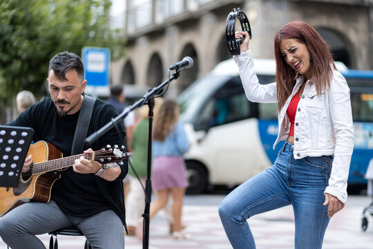 musical couple giving a concert in the street