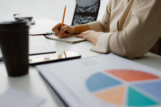 Anonymous business chart write data statistic workplace
