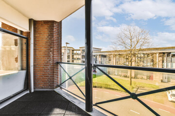 an outside area with brick walls and glass doors, looking out onto the street in front of the apartment building