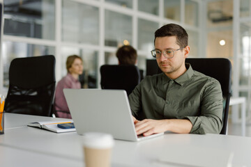 Busy worker using device modern office