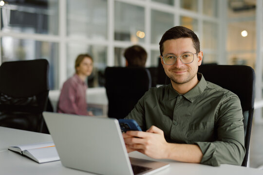 Confident manager working laptop contemporary workspace