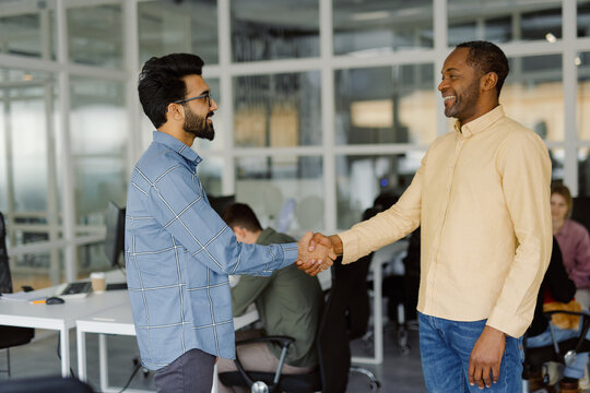 Office colleague greeting partnership achievement