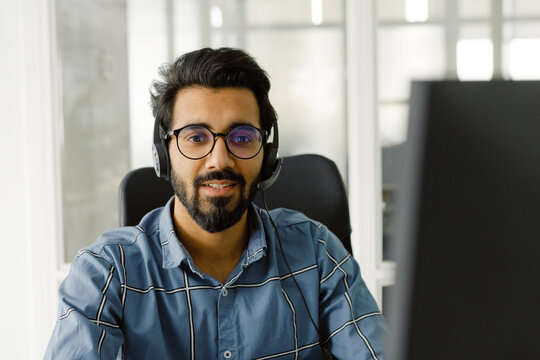 Office worker use device sitting indoors