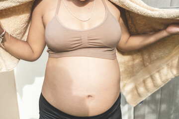 6 months pregnant woman showing big belly.