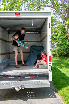 Dad and Kids Play Inside an Empty Truck on Moving Day