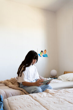 Girl using ipad at bedroom