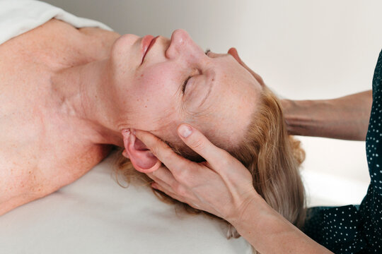 Matute woman having head massage at spa.