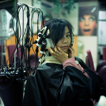 The woman is perming her hair