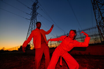 Cool man and woman dancing in evening