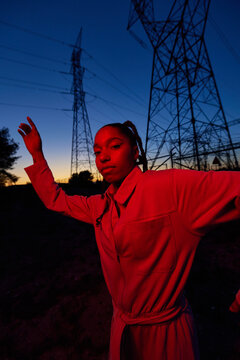 Young woman illuminated by neon light