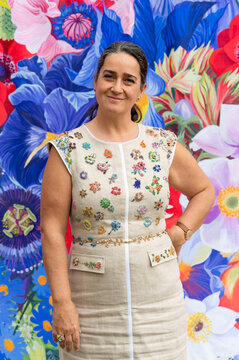 An artist standing on front of their work