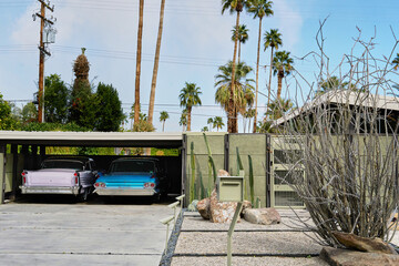 Vintage cars in carport of mid century modern home