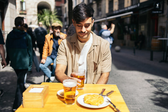 Man in Madrid eating typical spanish food