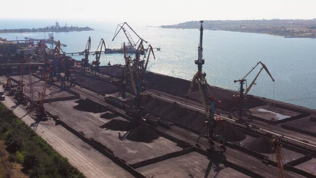 Tanker ship and idle cranes in the sea port. Logistic and transportration.