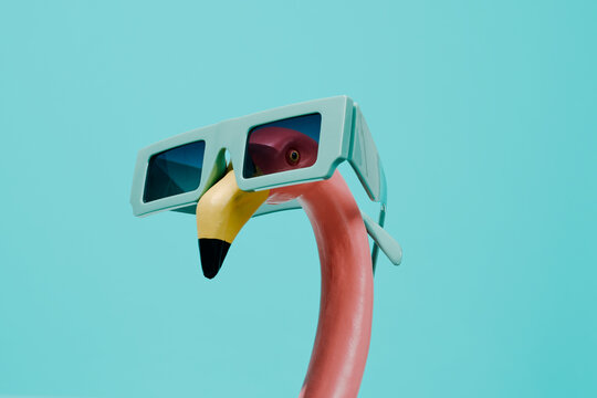 fake pink flamingo wearing sunglasses