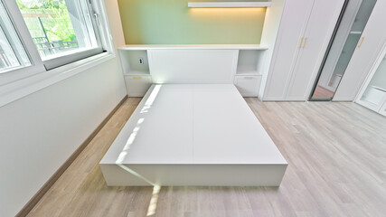 A bed made of custom-made furniture enhances the sense of unity in the interior