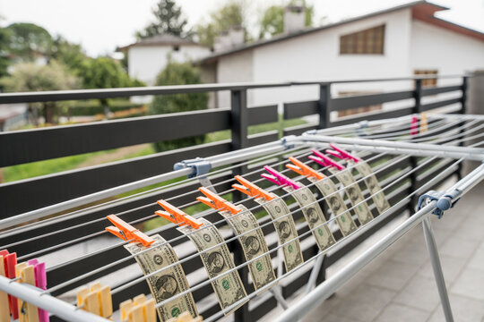 Dollar bills placed to dry on a clothesline