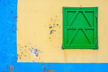 colorful yellow and blue wall and green window