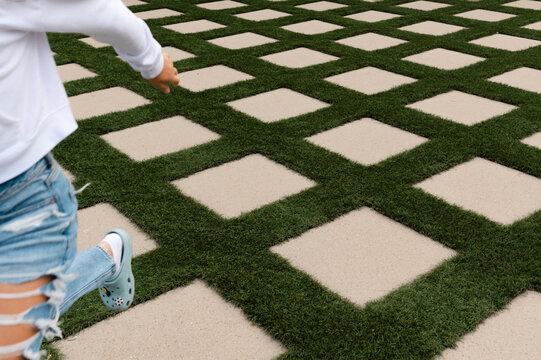 Person runs across concrete pavers