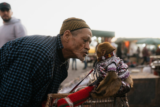Moroccan man with monkey in a costume