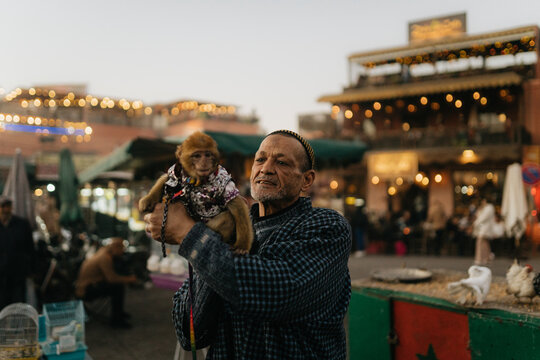 Moroccan man with monkey in a costume