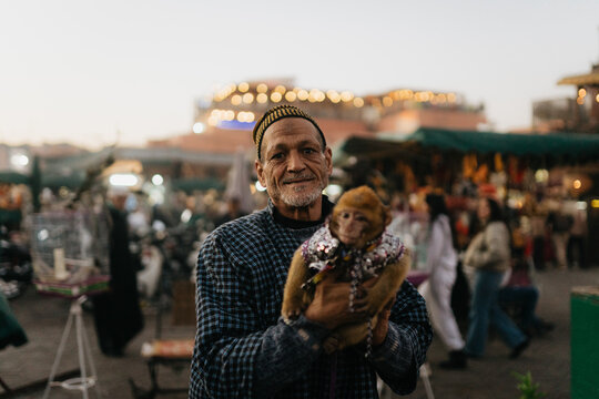 Moroccan man with monkey in a costume