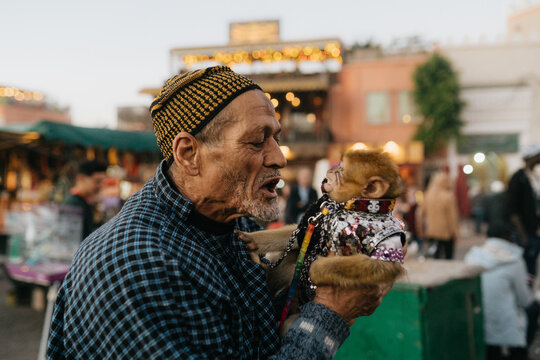 Moroccan man with monkey in a costume