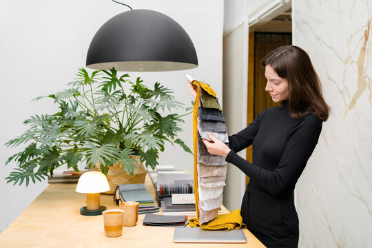 A woman interior designer works in her studio