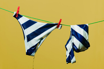 wet bikini hanging from a clothesline