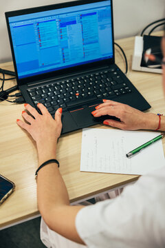 Crop woman working on laptop in clinic