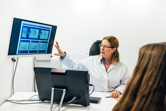 Doctor showing monitor with fertilization process