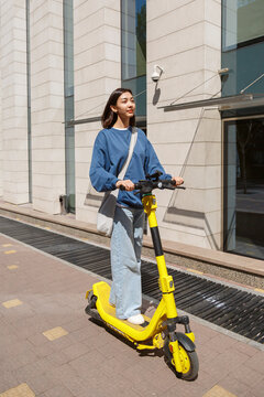 Asian Woman Riding E Scooter