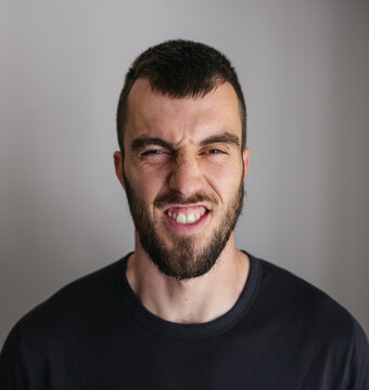 Scrunchy face studio portraits of visually impaired man.