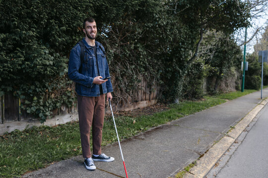 Happy portrait of blind guy on the sidewalk.