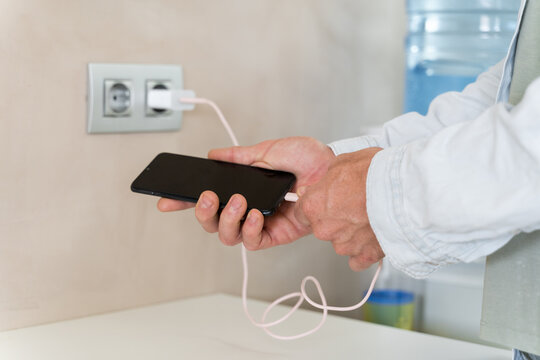 Man charging phone battery 