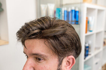 bald man with wig being styled in beauty salon