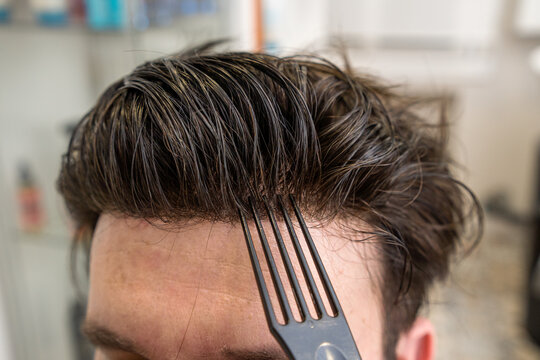 bald man with wig being styled in beauty salon