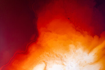 Abstract water on vibrant orange and red colors. Top view