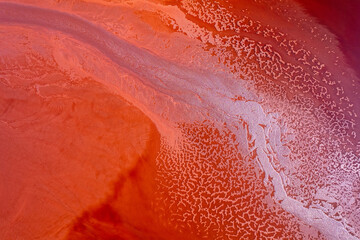 Abstract water on vibrant orange and red colors. Top view