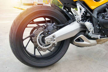 Obraz premium motorcycle fragment.rear wheel sports bike.motorcycle tyre big bike.closeup rear wheel of bigbike motorcycle 