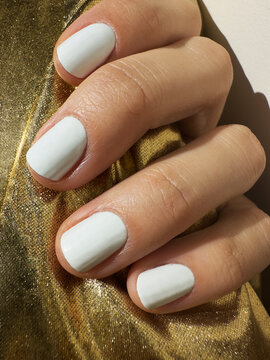 white nails and golden background